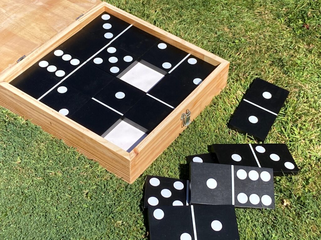 Black dominoes in handmade wooden box for garden parties
